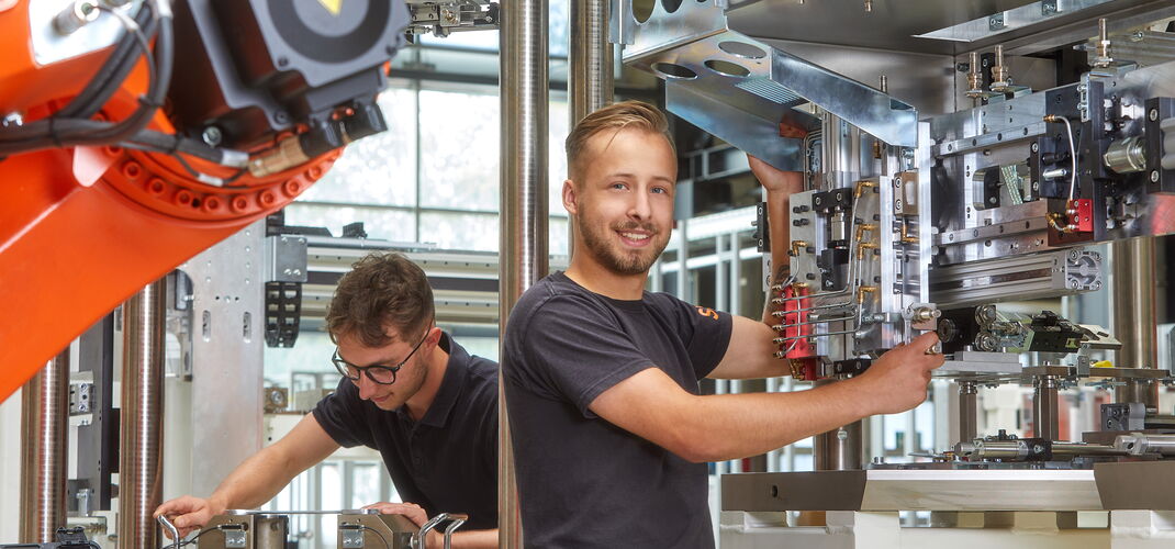 Two SITEC employees carrying out assembly work on a system.